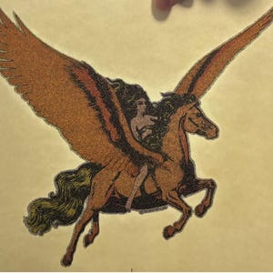May include: A vintage illustration of a winged horse with a woman riding on its back. The horse is brown with a gold mane and tail. The woman is wearing a long, flowing dress and has long, dark hair. The background is a light yellow.