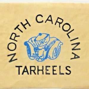 May include: A vintage, light brown paper bag with a black and blue logo that reads "NORTH CAROLINA TARHEELS". The logo features a blue mascot with the letters "UNC" on its hat.
