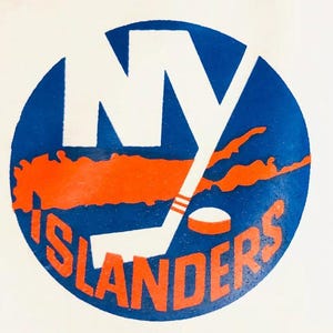 May include: A blue and orange hockey team logo with the letters "NY" and the word "ISLANDERS" in a circle. The logo features a hockey stick and a puck.