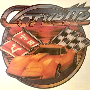 May include: A graphic illustration featuring an orange sports car positioned in front of two crossed flags, one red with a white fleur-de-lis and one black and white checkered, all enclosed in a circular frame with the word Corvette in large text.