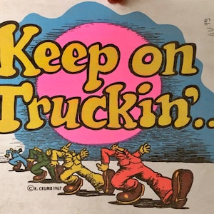 May include: A vintage poster with a yellow and black graphic of the text "Keep on Truckin..." with a pink circle behind the text.  Five cartoon figures are walking in a line at the bottom of the poster.  The poster is signed "R. Crumb 1967".
