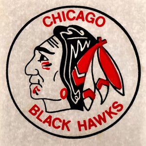 May include: A black and white logo of a Native American man's profile with a red feather headdress. The logo is in a circle with the words "CHICAGO BLACK HAWKS" in red.