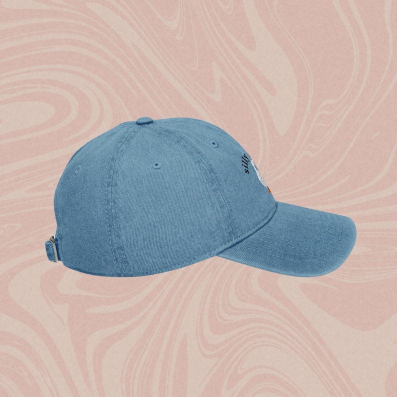 May include: A blue denim baseball cap with the text "Silly" embroidered on the front in black.