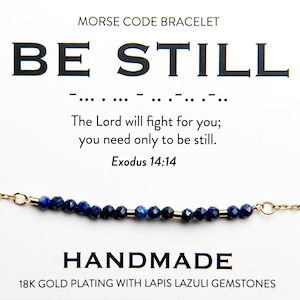 May include: A gold bracelet with blue lapis lazuli gemstones. The bracelet spells out "BE STILL" in Morse code. The text below reads "The Lord will fight for you; you need only to be still. Exodus 14:14".