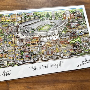 May include: A detailed color print titled "Pubs of East Lansing II" featuring an illustrated map of a stadium and surrounding businesses. The artwork includes a signature in the bottom right corner and the edition number 11/2500 in the bottom left.