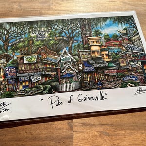 May include: A colorful illustration of a street scene in Gainesville, Florida, with various pubs and bars depicted. The image is titled "Pubs of Gainesville" and numbered 108/250.