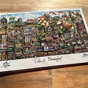 May include: A colorful illustration of a city scene with buildings and shops, titled "Pubs of Bloomington". The image is numbered 1518/2500, indicating it is a limited edition print.