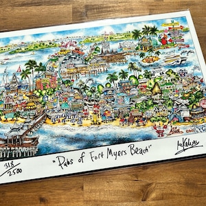 May include: A colorful hand-drawn illustration of a map of Fort Myers Beach, Florida. The map shows the location of various bars and restaurants. The title of the map is "Pubs of Fort Myers Beach". The map is signed by the artist, "MyKelvis". The map is numbered 318/2500.