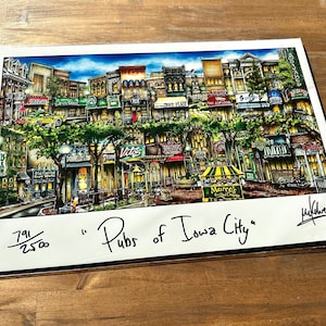 May include: A colorful illustration of a city street scene with multiple buildings, each depicting a different pub or bar. The image is titled "Pubs of Iowa City" and is numbered 791/2500.