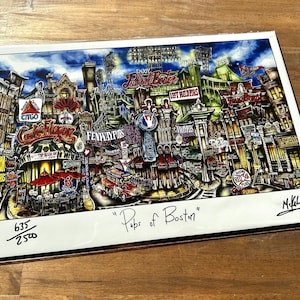 May include: A colorful print titled "Pubs of Boston" featuring a detailed illustration of Boston landmarks and businesses. The artwork includes the Citgo sign, Fenway Park, and other iconic locations. The print is numbered 635/2500.