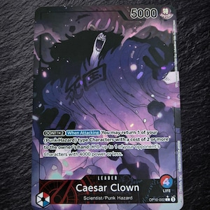 May include: A One Piece trading card featuring the character Caesar Clown as a leader. The card has a dark purple and black color scheme with glowing particles. It displays the text Caesar Clown, Scientist/Punk Hazard, 5000 power, and 4 life.