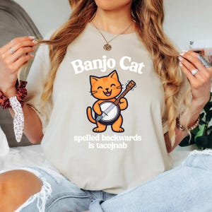 Banjo Cat Spelled Backwards Cartoon Animal Print Graphic Tee Funny Unisex Musician Shirt Cat Playing Banjo Banjo Player Gift Bluegrass Shirt
