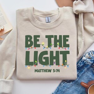 Be the Light Sweatshirt: Christian Christmas Apparel