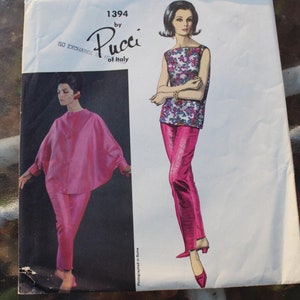May include: Vintage Vogue Couturier Design sewing pattern by Pucci of Italy. The pattern features illustrations of a woman in a pink ensemble and a patterned top with pink pants. The text "VOGUE COUTURIER DESIGN" is at the top.