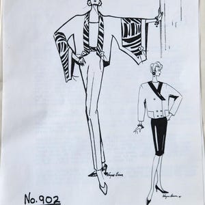 May include: A white sewing pattern envelope by Carol Lane, No. 902, featuring black ink illustrations of two outfits. The left figure wears a wide-sleeved jacket and trousers, while the right figure wears a double-breasted jacket and skirt.