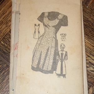 May include: A vintage paper sewing pattern envelope in a light tan color. The front features a black line drawing of a dress with a floral pattern, a smaller sketch of the back, and the text 4930 SIZES S. M. L. Ex. L. The paper shows signs of age.