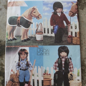 May include: A Vogue Doll Collection sewing pattern envelope, number 7729, featuring illustrations of dolls dressed in equestrian and farm-themed outfits, including a horse with a blanket, a rider, a person with a shovel, and a person with a rope.