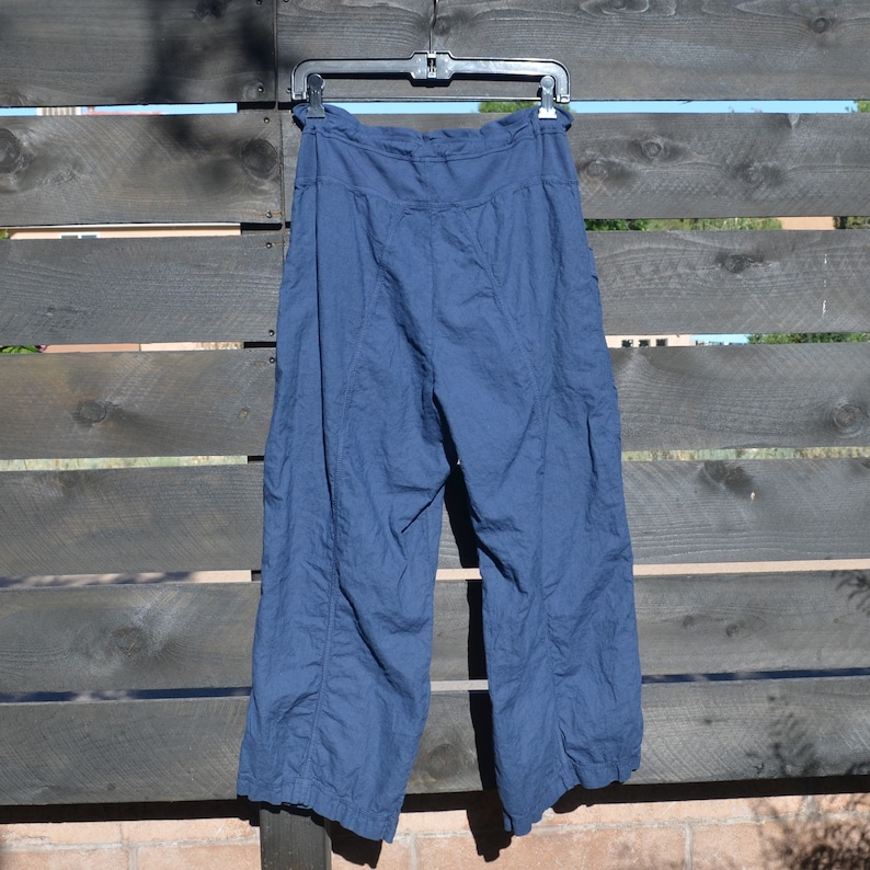 Puede incluir: Un pantal&oacute;n de pierna ancha de color azul oscuro con cintura de cord&oacute;n.