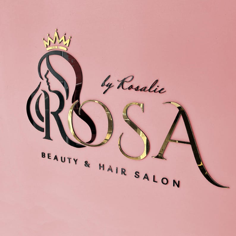 May include: A black and gold logo for a beauty and hair salon called "ROSA by Rosalie". The logo features a stylized image of a woman's head with a crown above it.