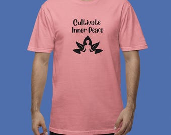 May include: A pink t-shirt with the text "Cultivate Inner Peace" and a black silhouette of a person meditating on a lotus flower.
