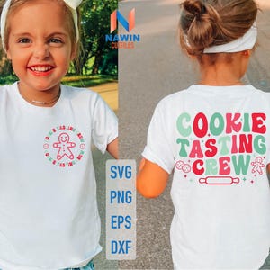 May include: White t-shirts with colorful text and graphics. One shirt features a gingerbread man and the words "Cookie Tasting Crew." The other shirt has the words "Cookie Tasting Crew" in a retro font. The shirts are for children.