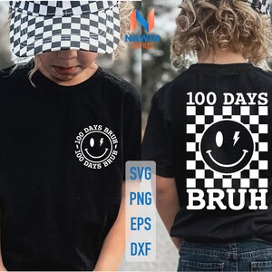 K&ouml;nnte beinhalten: Ein schwarzes T-Shirt mit einem wei&szlig;en Karomuster und einem Smiley mit einem Blitz. Der Text "100 Days  Bruh" ist auf dem T-Shirt aufgedruckt.