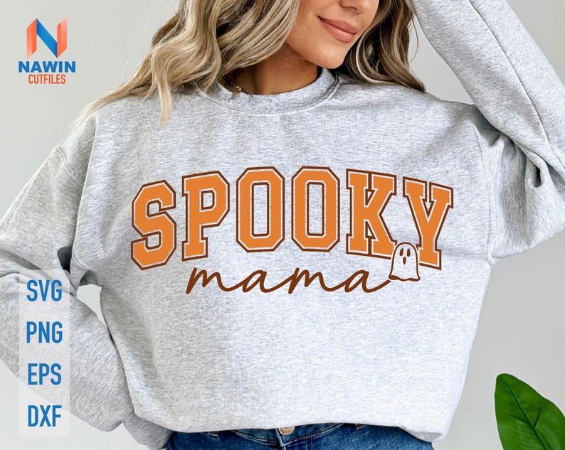 May include: A light gray sweatshirt with the words "SPOOKY mama" in orange and brown lettering. A small ghost graphic is next to the word "mama". The sweatshirt also has the words "SVG, PNG, EPS, DXF" in a vertical column.
