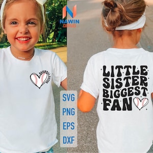 May include: Two children wearing white t-shirts with baseball-themed designs. The girl on the left has a heart-shaped baseball design with the text "Baseball Sister". The girl on the right has the text "Little Sister Biggest Fan" with a baseball in a heart shape.