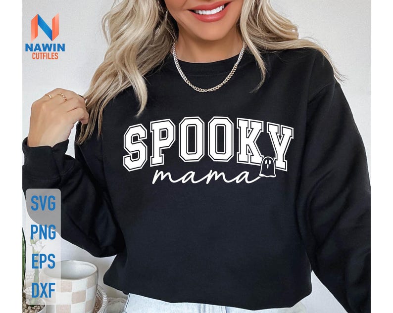 May include: Black sweatshirt with the words "SPOOKY mama" in white block letters and a ghost graphic. The sweatshirt also has the words "SVG, PNG, EPS, DXF" in a vertical stack on the left side.