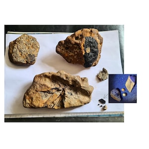 May include: Image of several rough, brown rocks with varying textures and sizes. A ruler is at the bottom. A smaller inset shows additional rocks and what appear to be small gold nuggets and a diamond-shaped stone.