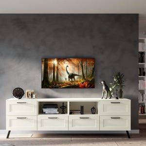 May include: White entertainment center with four drawers and three open shelves. The center has black metal legs and is against a gray wall. A framed print of a dinosaur in a forest is above the entertainment center.