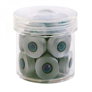 May include: A clear plastic jar filled with several spools of gray thread. Each spool has a dark blue center. The jar has a clear lid. The thread spools are neatly arranged inside the container.