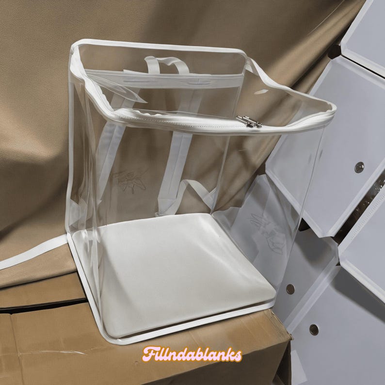 May include: A clear plastic storage bag with a white zipper and white straps. The bag is empty and has a white base.