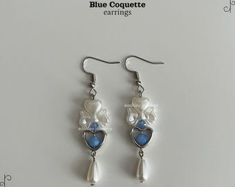 Orecchini a fiocco blu coquette, delicati gioielli con nastro pendente, stile romantico e dolce.