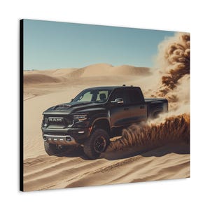 May include: A black Ram pickup truck driving through a desert landscape, kicking up a cloud of sand. The truck has a black grille with the word "RAM" in red letters.