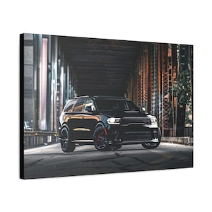May include: A black Dodge Durango SRT with red accents is parked in front of a brick building. The SUV has a black grille and black wheels.