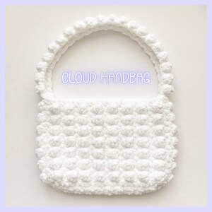 May include: White crocheted handbag with a puffy texture and a rounded handle. The bag has the text "CLOUD HANDBAG" printed on it.