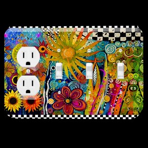May include: A decorative light switch and outlet cover featuring a vibrant floral design. The cover has a colorful abstract pattern with flowers, swirls, and a sun. The edges are bordered with a black and white checkered pattern.