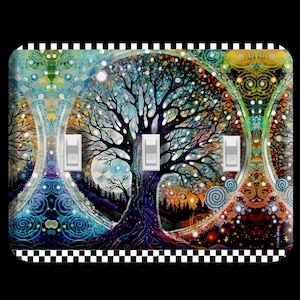 May include: A decorative light switch cover featuring a vibrant, colorful tree of life design. The artwork includes a black and white checkered border and three light switches. The color palette includes blues, greens, oranges, and purples.