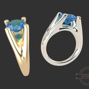 May include: A ring with a blue gemstone set in a gold band. The ring is shown from two different angles.