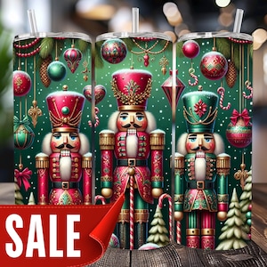 May include: Three stainless steel tumblers with a Christmas nutcracker design. The tumblers feature a green background with ornaments, candy canes, and Christmas trees. The word "SALE" is displayed on a red banner.