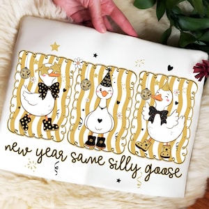 May include: White pillowcase with a festive design featuring three cartoon geese in party hats and bow ties, set against a gold and white striped background. The text "new year same silly goose" is written in black script.