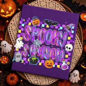 May include: A square purple canvas featuring the text Spooky Season in a holographic font. The design includes a checkered background with illustrations of a jack-o'-lantern, a bat, a witch hat, a ghost, a tombstone, a spider web, a cauldron, and a potion.