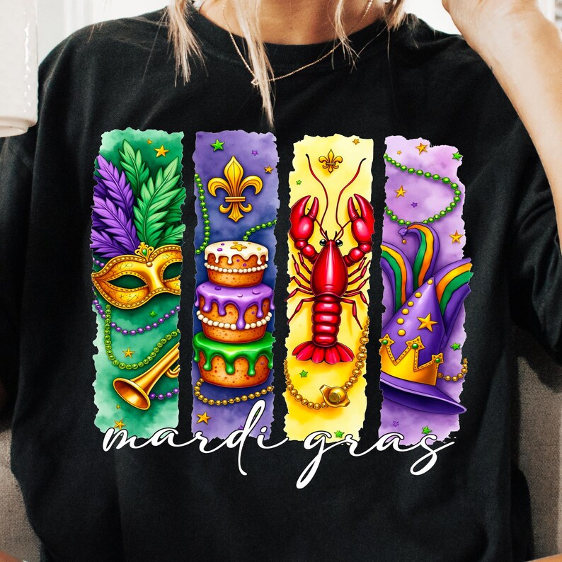 May include: A black t-shirt with a colorful design featuring Mardi Gras symbols. The design includes a mask, a cake, a crawfish, and a jester's hat. The text "Mardi Gras" is written below the design.