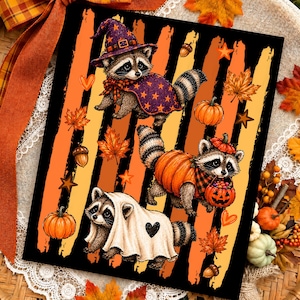 May include: A rectangular print featuring three raccoons in Halloween costumes against a background of vertical black and orange stripes. One raccoon wears a purple star-patterned witch hat and cape, another wears a pumpkin suit, and one wears a ghost sheet.
