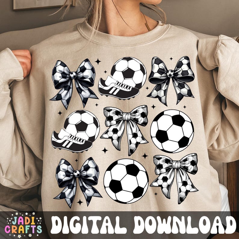 May include: Beige sweatshirt with a soccer theme design. The design includes soccer balls, soccer cleats, and bows with soccer ball patterns. The words "DIGITAL DOWNLOAD" are at the bottom. The JADI CRAFTS logo is in the lower left corner.
