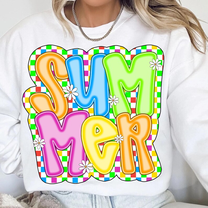 May include: White sweatshirt with a colorful graphic of the word "SUMMER" in a retro style with a checkered background and white daisies.