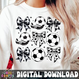 May include: White sweatshirt with a repeating pattern of black and white soccer balls, cleats, and bows. The words "DIGITAL DOWNLOAD" are printed at the bottom. The design includes small star accents.