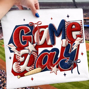 May include: White pillowcase with a baseball theme, featuring the words "Game Day" in red, white, and blue. The design includes baseballs, stars, a bat, and lightning bolts. The pillowcase is held by a person.
