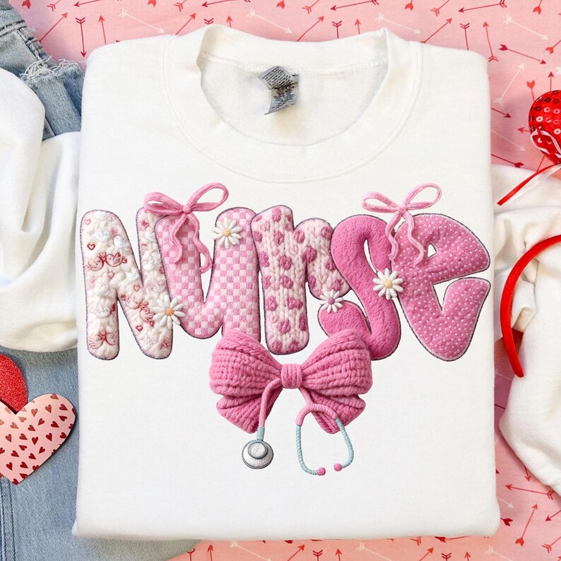 May include: White sweatshirt with the word "NURSE" in pink, decorated with bows and flowers. A pink bow and stethoscope are below the word. The letters have different patterns, including hearts and daisies.